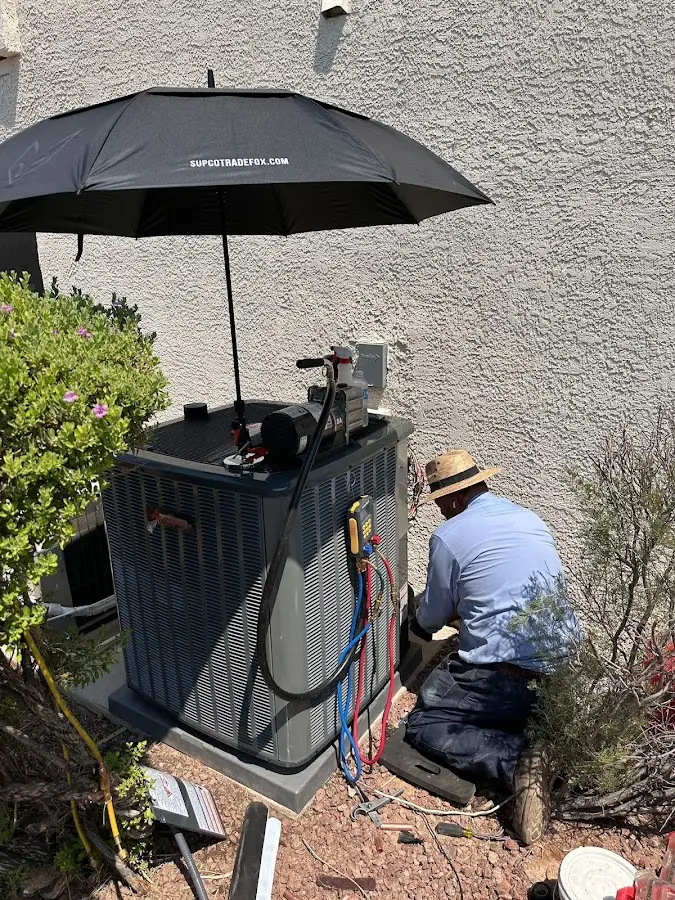 HVAC technician performing outdoor AC maintenance in Portage